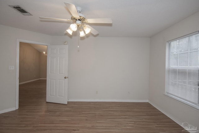 spare room with hardwood / wood-style floors and ceiling fan