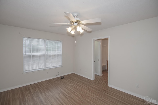 unfurnished room featuring hardwood / wood-style floors and ceiling fan