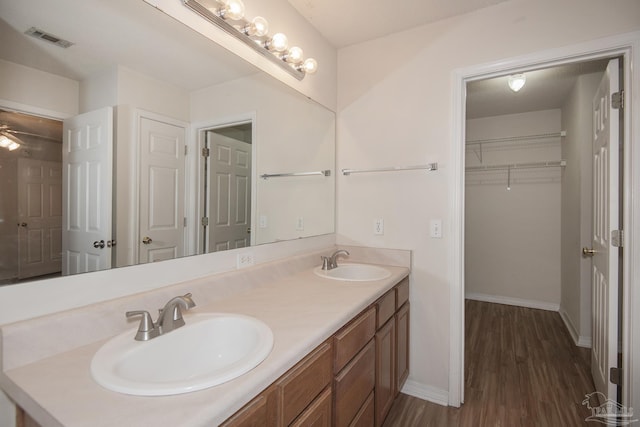 bathroom featuring hardwood / wood-style floors, vanity, and ceiling fan