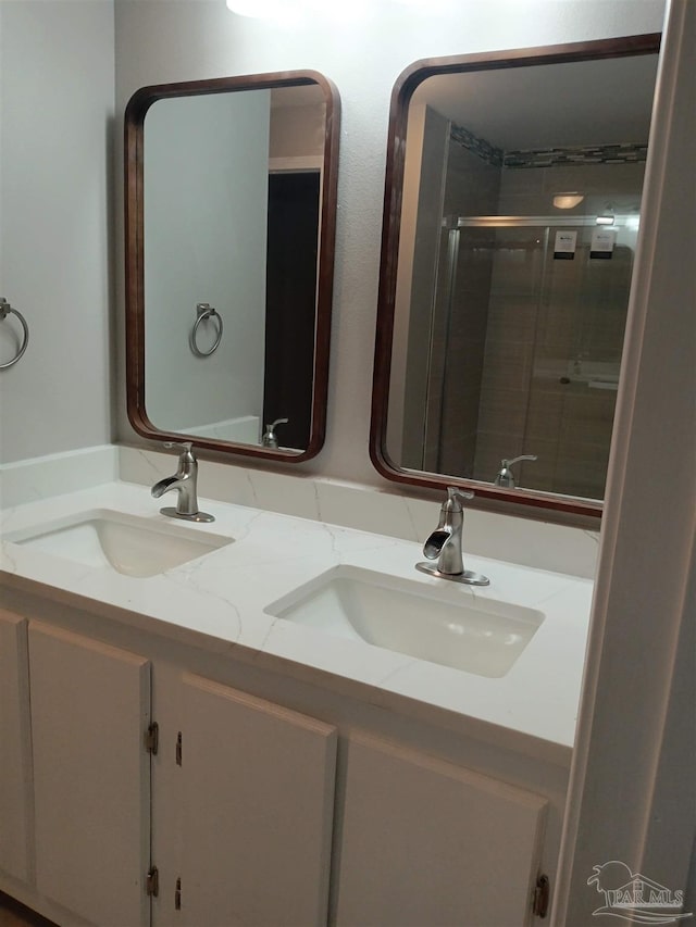 bathroom with vanity and a shower with shower door