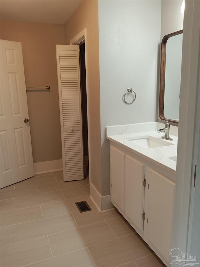 bathroom featuring tile patterned flooring and vanity