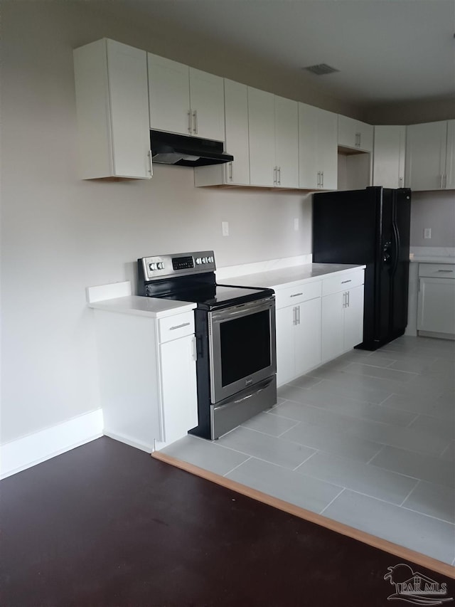 kitchen featuring black fridge, electric range, and white cabinetry