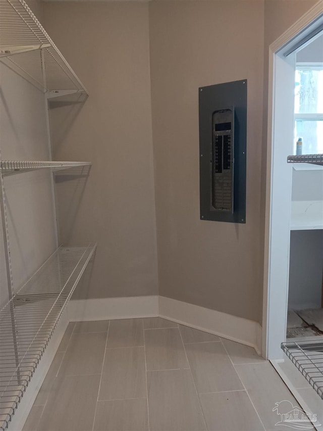 spacious closet with electric panel and tile patterned floors