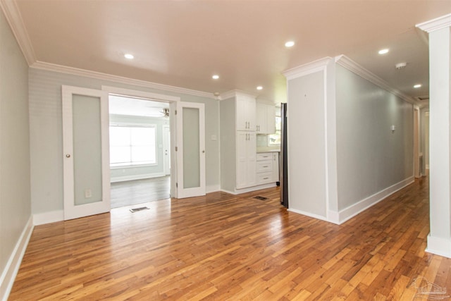 empty room with crown molding, hardwood / wood-style flooring, and ceiling fan