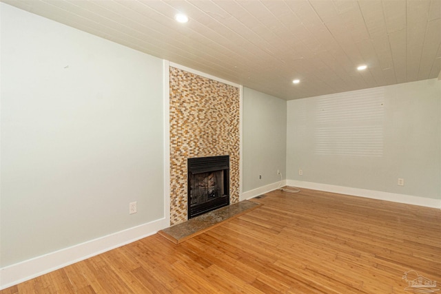 unfurnished living room featuring a fireplace and light hardwood / wood-style floors