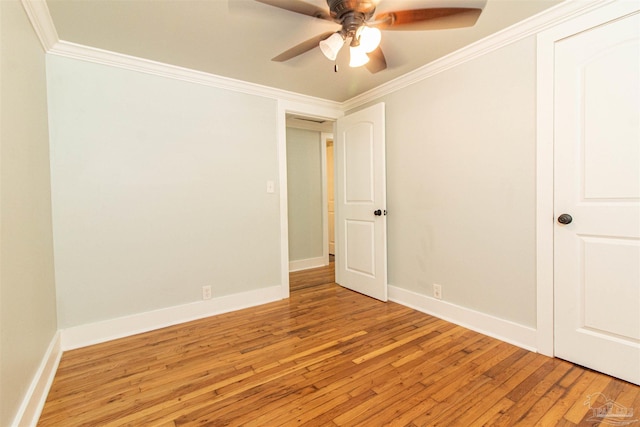 empty room featuring crown molding, light hardwood / wood-style floors, and ceiling fan