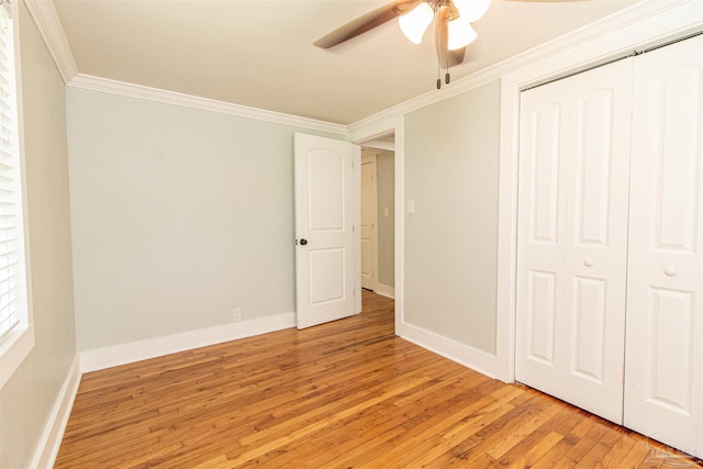 unfurnished bedroom with light hardwood / wood-style floors, ornamental molding, a closet, and ceiling fan