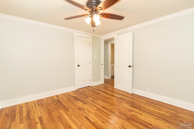 spare room with crown molding, hardwood / wood-style floors, and ceiling fan