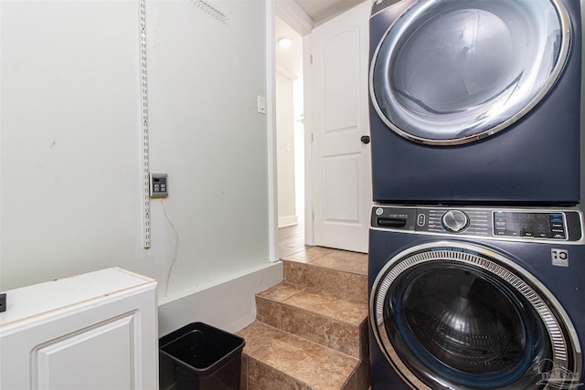 laundry area with stacked washer and clothes dryer