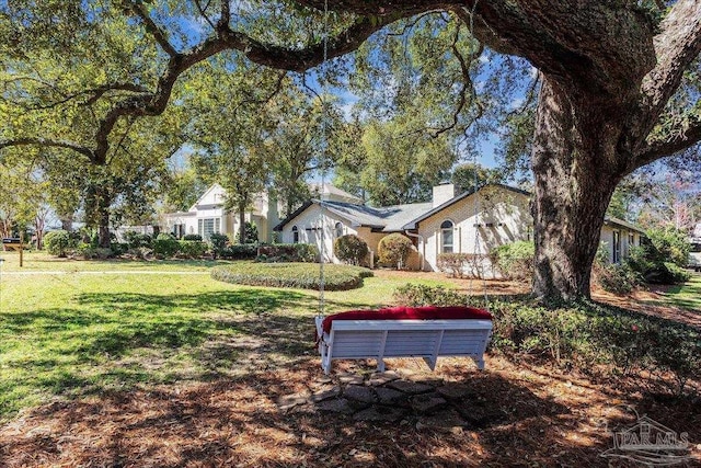 exterior space with a front lawn and a chimney