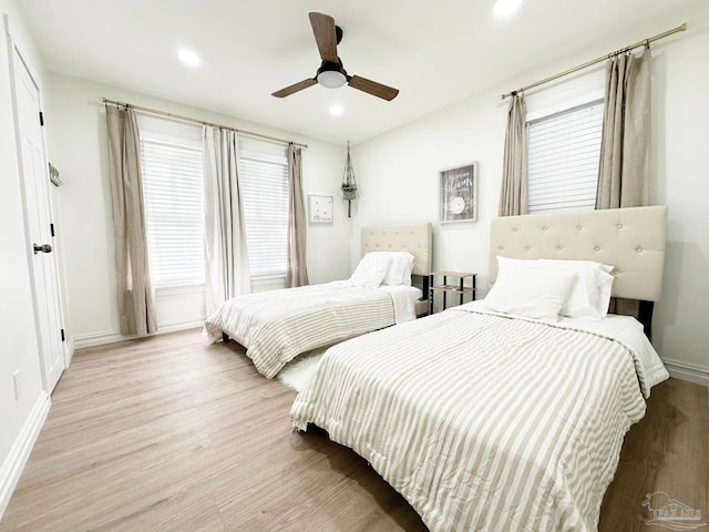 bedroom with baseboards, wood finished floors, recessed lighting, and a ceiling fan
