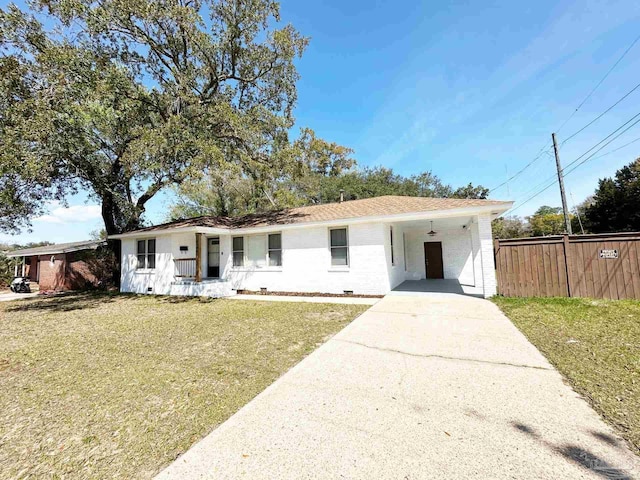 single story home with fence, crawl space, driveway, a front lawn, and a carport