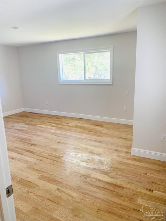 unfurnished room with light wood-type flooring