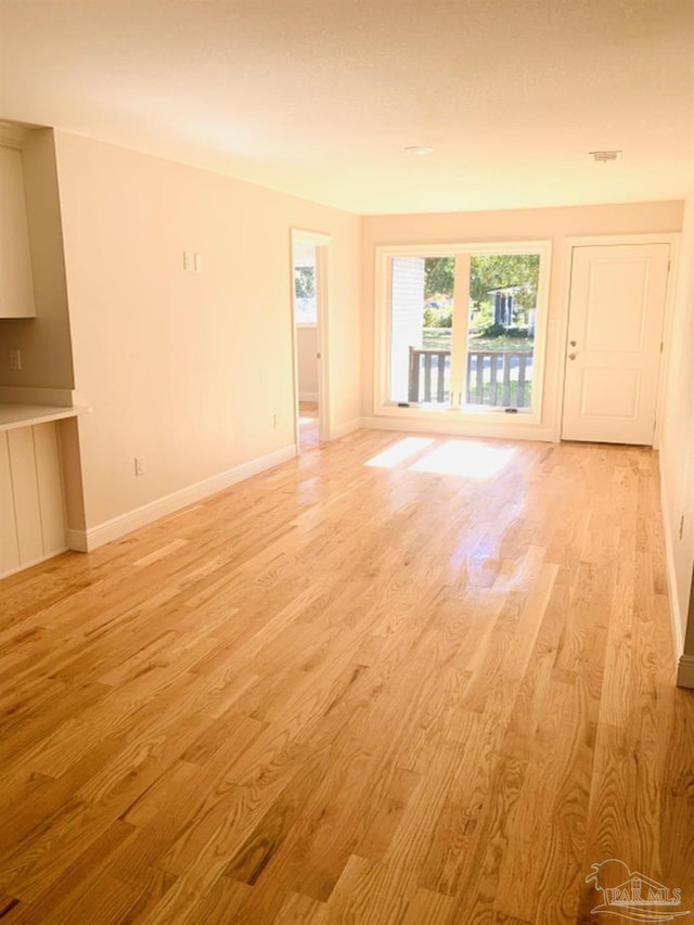 unfurnished living room featuring light wood-type flooring