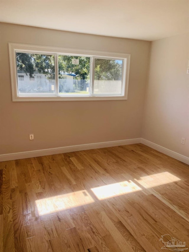 unfurnished room with light wood-type flooring