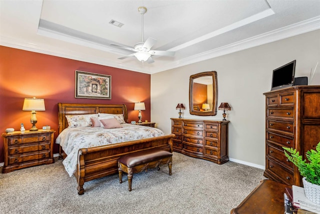 bedroom with ceiling fan, crown molding, a raised ceiling, and carpet flooring