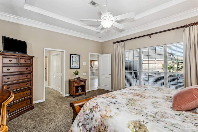 carpeted bedroom featuring ceiling fan, a raised ceiling, and ornamental molding