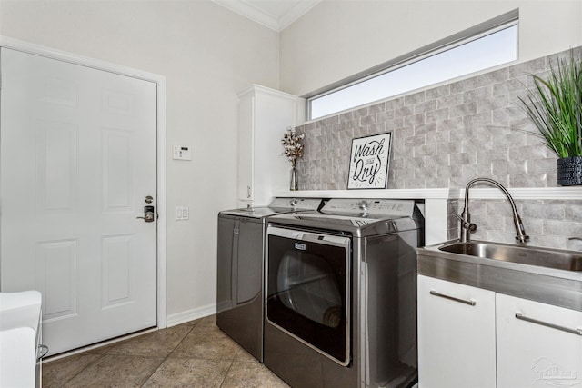 laundry room with washing machine and dryer, cabinets, a wealth of natural light, and sink