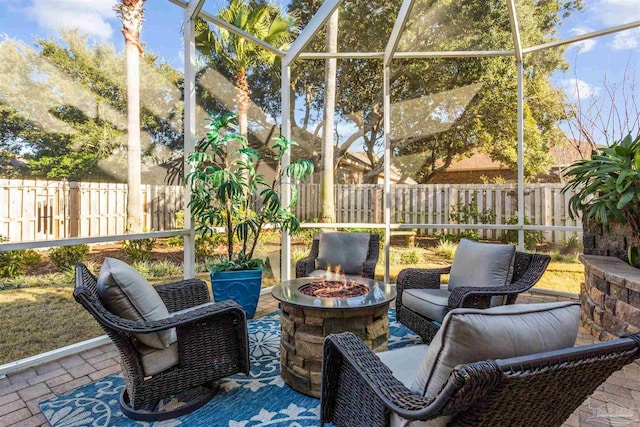 view of patio with a lanai and an outdoor fire pit