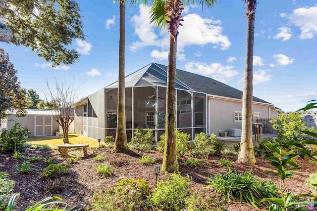 back of property featuring central AC unit and glass enclosure