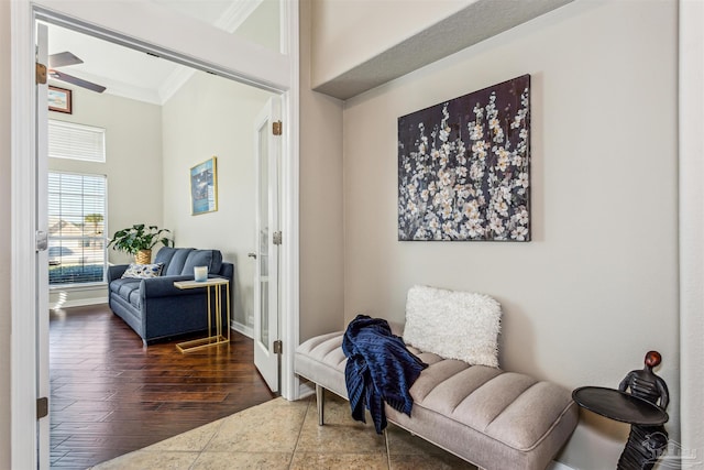 living area with ceiling fan, dark hardwood / wood-style floors, and crown molding