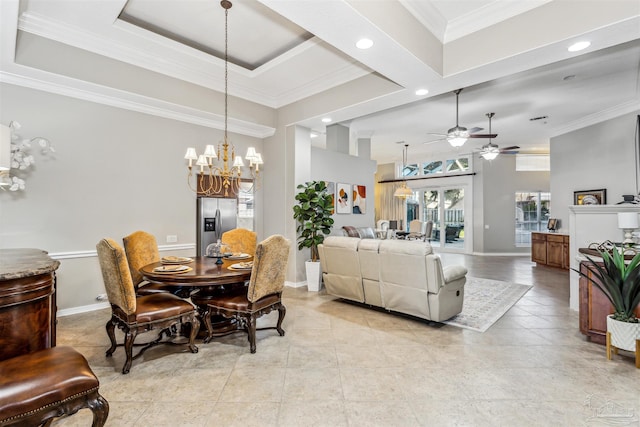 dining area with ceiling fan with notable chandelier, a raised ceiling, and ornamental molding