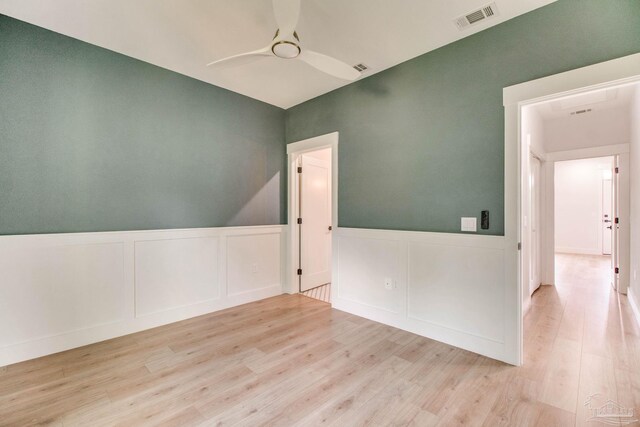 608 E Leonard Unit A & B, Pensacola, FL 32503 - empty room with wood finished floors, a ceiling fan, a decorative wall, and a wainscoted wall