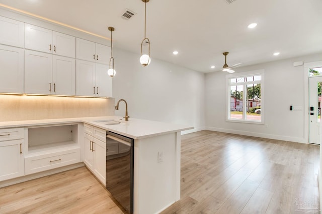 608 E Leonard Unit A & B, Pensacola, FL 32503 - kitchen featuring a sink, a ceiling fan, beverage cooler, a peninsula, and light wood-type flooring