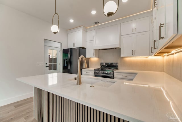 608 E Leonard Unit A & B, Pensacola, FL 32503 - kitchen with stainless steel gas stove, black refrigerator with ice dispenser, a sink, light countertops, and recessed lighting