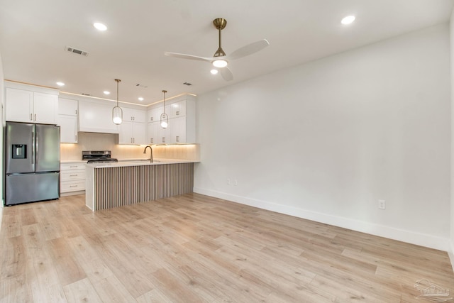608 E Leonard Unit A & B, Pensacola, FL 32503 - kitchen featuring stainless steel refrigerator with ice dispenser, stove, baseboards, a sink, and white cabinets