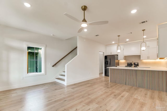 608 E Leonard Unit A & B, Pensacola, FL 32503 - kitchen featuring stainless steel fridge, white cabinets, a ceiling fan, a peninsula, and decorative light fixtures