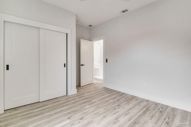 608 E Leonard Unit A & B, Pensacola, FL 32503 - unfurnished bedroom with light wood finished floors, a closet, and baseboards