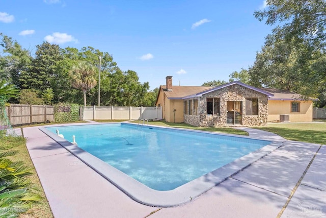 view of pool featuring cooling unit and a patio