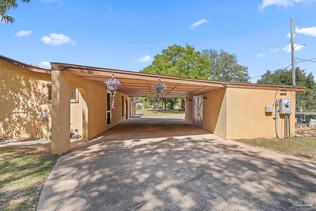 view of vehicle parking featuring a carport