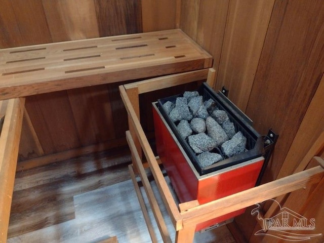 view of sauna / steam room with wooden walls and hardwood / wood-style floors