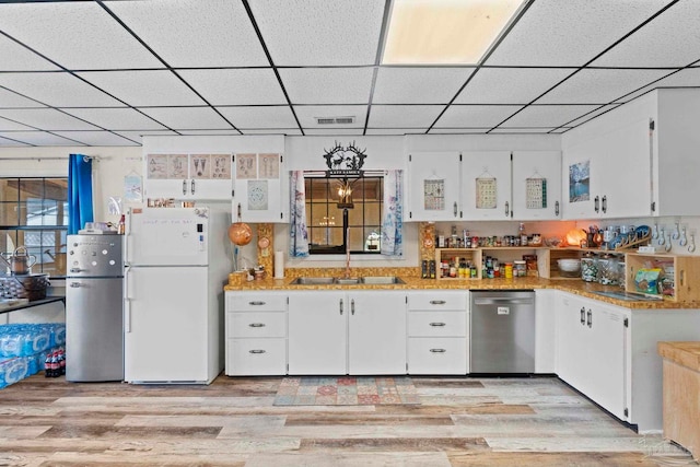 kitchen featuring light hardwood / wood-style floors, white cabinets, and appliances with stainless steel finishes