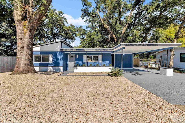 view of front of house featuring covered porch and a carport