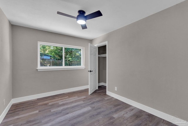 unfurnished bedroom featuring ceiling fan, a closet, and light hardwood / wood-style flooring