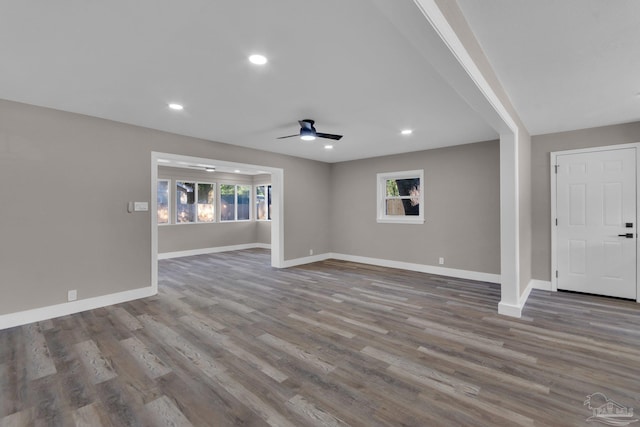 unfurnished living room with ceiling fan and hardwood / wood-style floors