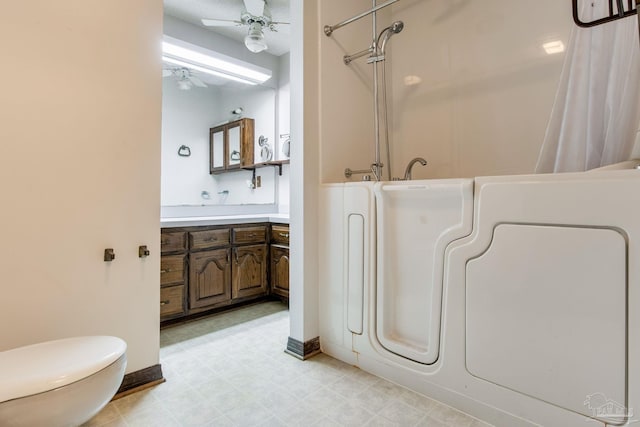 bathroom with ceiling fan, toilet, vanity, tile patterned floors, and washer / clothes dryer