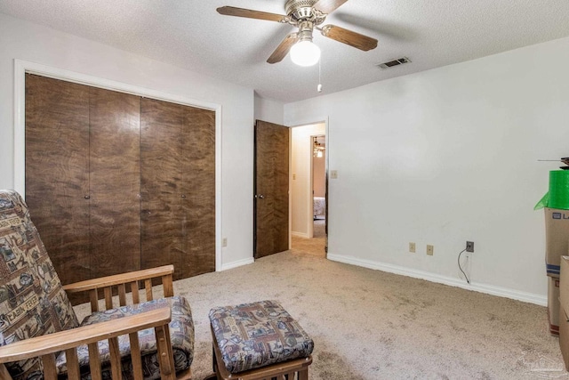 bedroom featuring visible vents, carpet flooring, ceiling fan, a textured ceiling, and baseboards