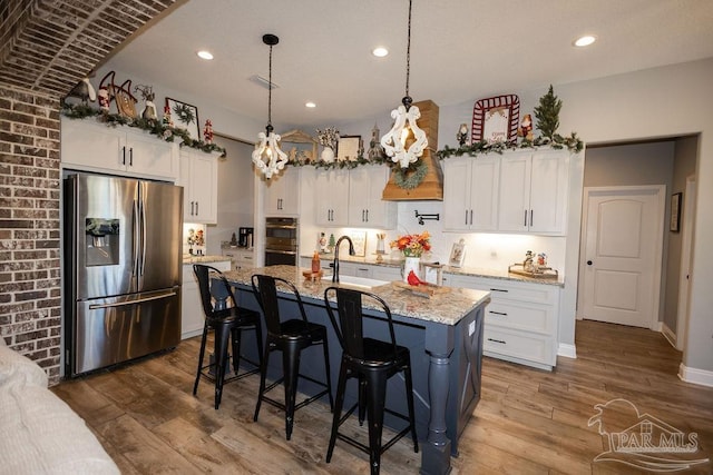 kitchen with white cabinets, stainless steel appliances, and sink