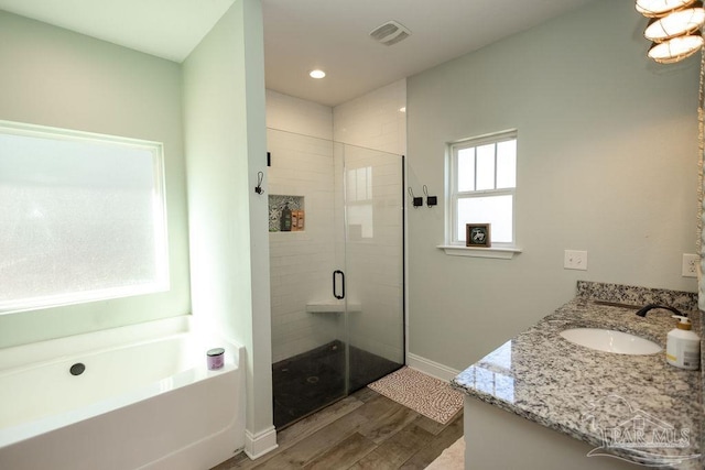 bathroom with vanity, shower with separate bathtub, and hardwood / wood-style flooring