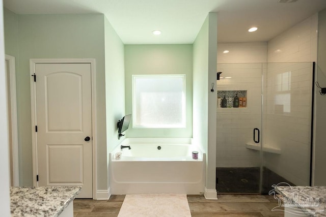 bathroom featuring wood-type flooring, vanity, and independent shower and bath