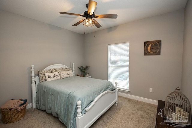 bedroom featuring ceiling fan and carpet