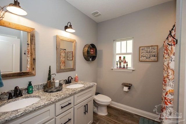 bathroom with vanity, wood-type flooring, and toilet