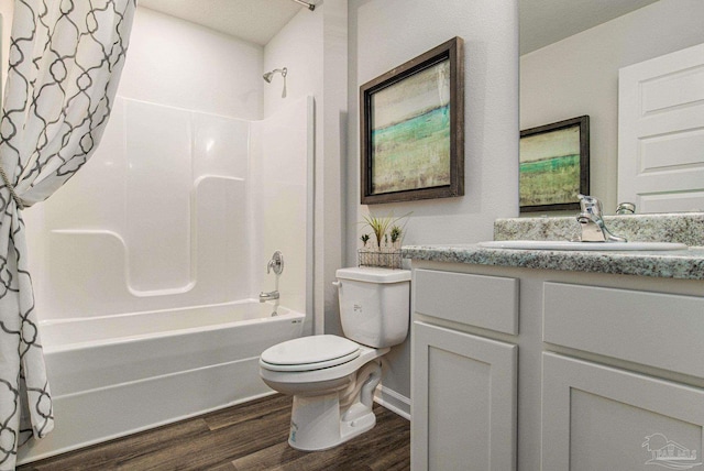 full bathroom with vanity, toilet, a textured ceiling, hardwood / wood-style floors, and shower / tub combo with curtain