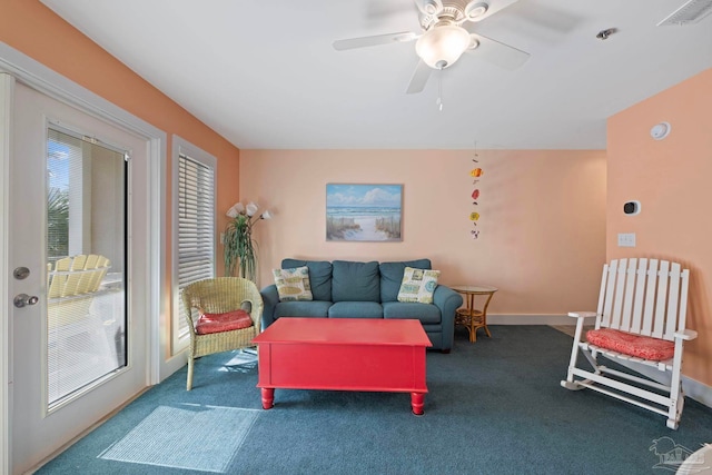 carpeted living room featuring plenty of natural light and ceiling fan