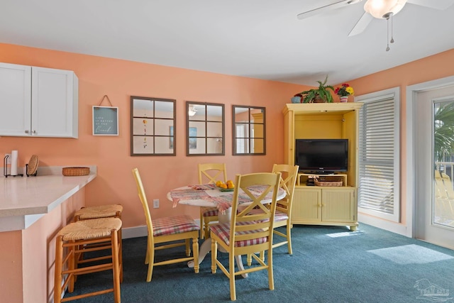 carpeted dining area featuring ceiling fan