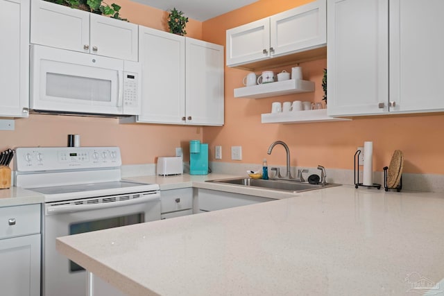 kitchen with sink, white appliances, and white cabinets